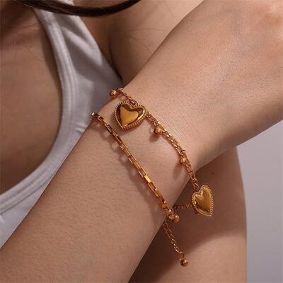 woman wearing gold layered heart charm bracelet anti tarnish stylish wrist jewellery