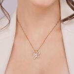 girl wearing pink butterfly pendant necklace gold chain aesthetic jewelry for women daily wear necklace neckline view