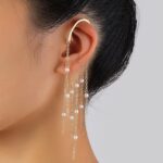 girl wearing gold pearl ear cuffs with long tassel dangle earrings