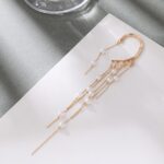 single gold pearl ear cuff with long tassel close up elegant jewellery