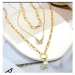 close up silver butterfly pendant on gold chain necklace