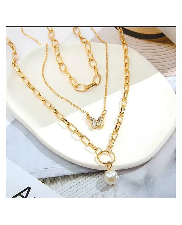 close up silver butterfly pendant on gold chain necklace