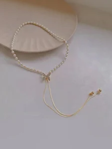 close up silver butterfly pendant on gold chain necklace