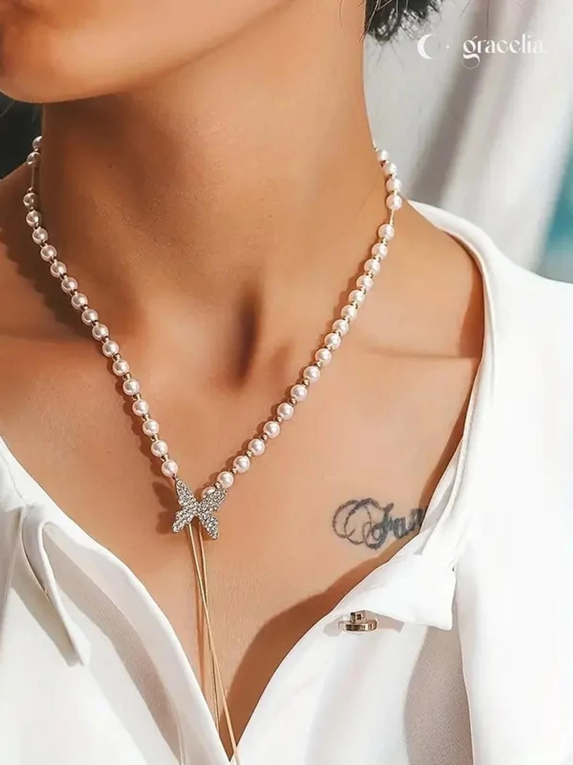 different woman wearing gold chain silver butterfly pendant necklace styled look